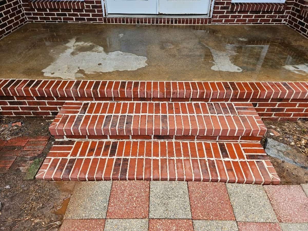 Cleaned red brick steps leading to a residential porch