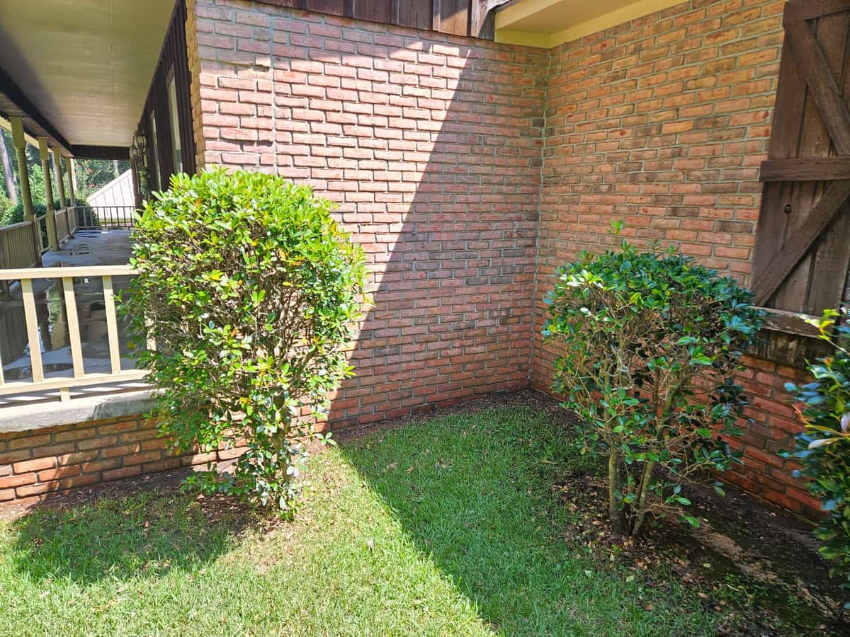 Brick masonry corner beside a porch and landscaping in Collins
