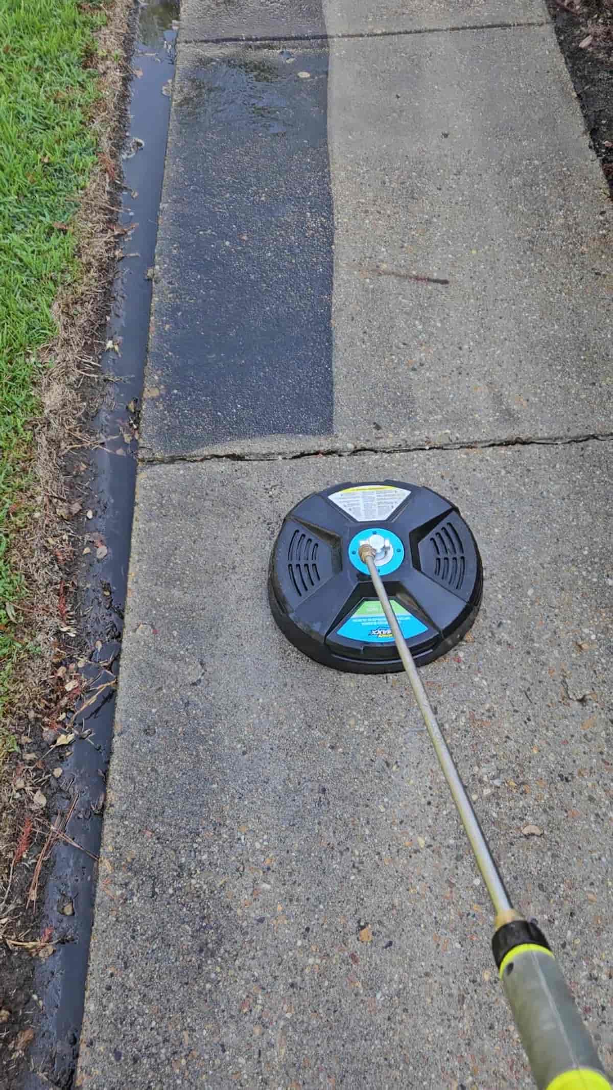 Surface cleaner at work on a concrete walkway in Collins, Mississippi