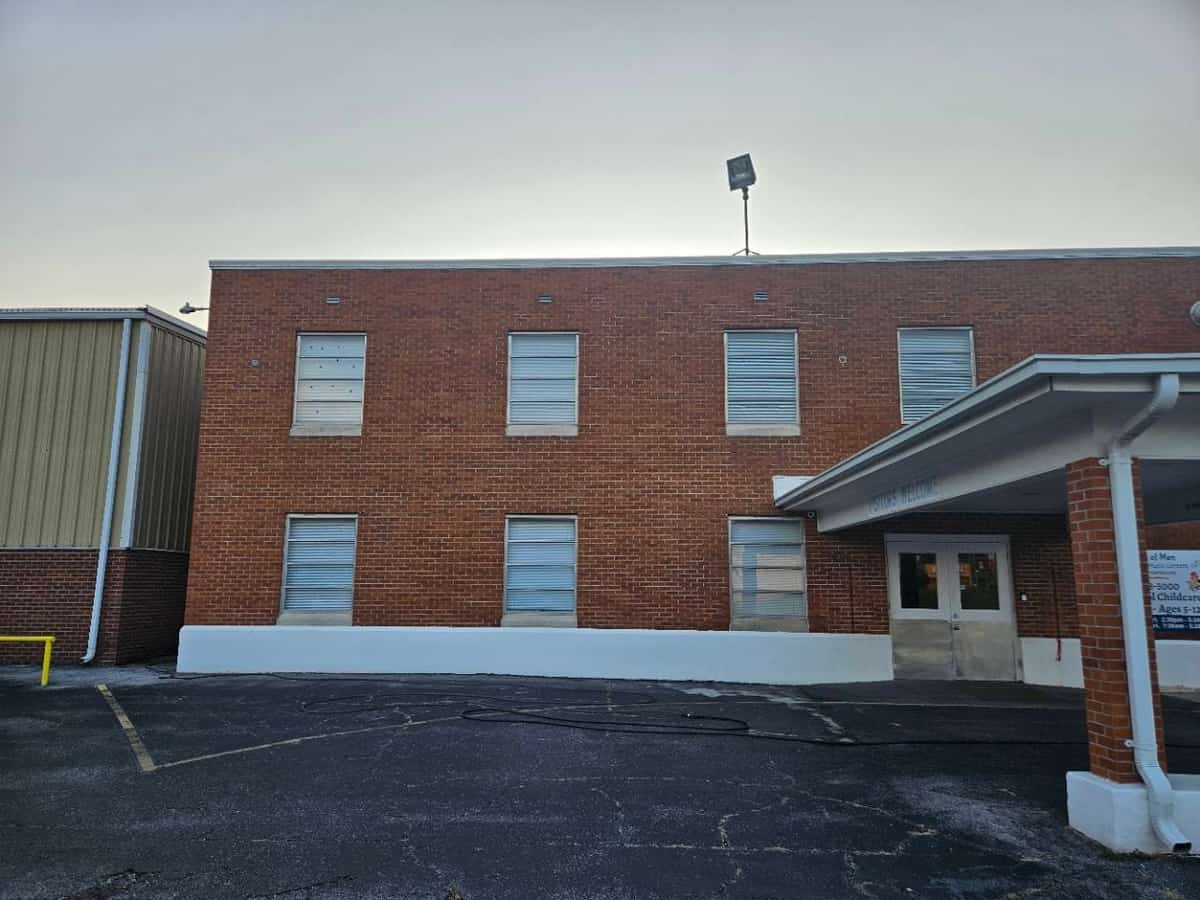 Brick building entrance and window sills after detail cleaning in Laurel