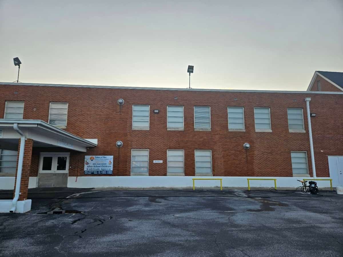 Long brick building with window sills after detail cleaning in Laurel