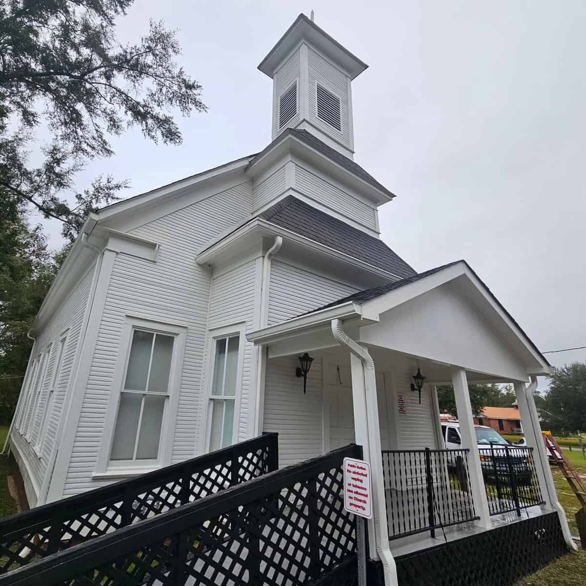 Cleaned white exterior, front entrance, and bell tower at Harvest Church in Sanford, Mississippi