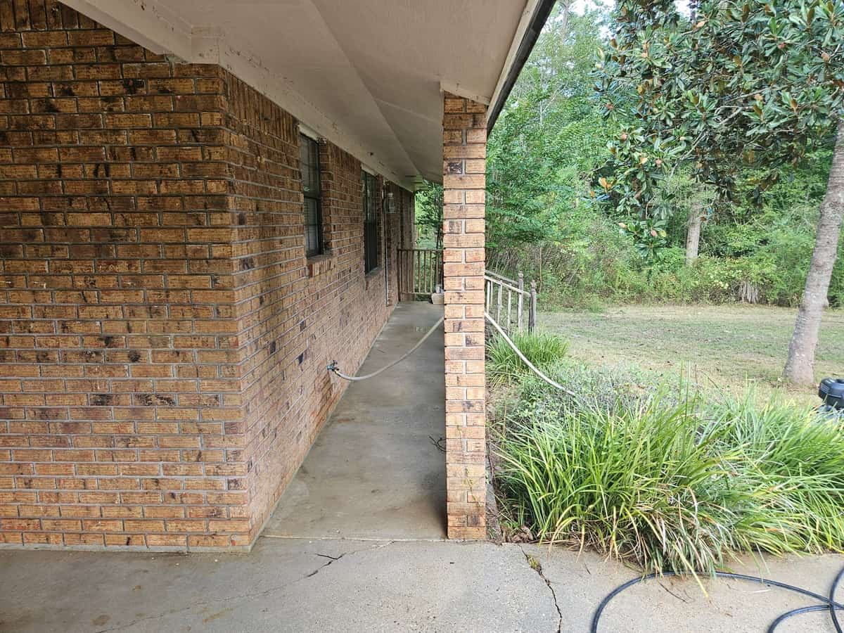 Cleaned covered walkway alongside a brick home in Seminary, Mississippi
