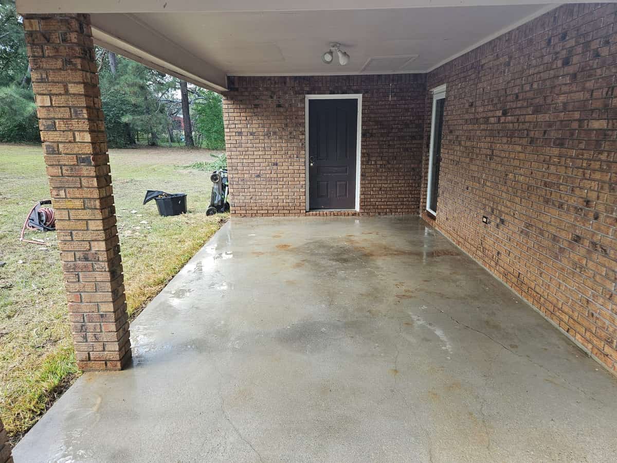 Cleaned covered carport concrete beside a brick home in Seminary