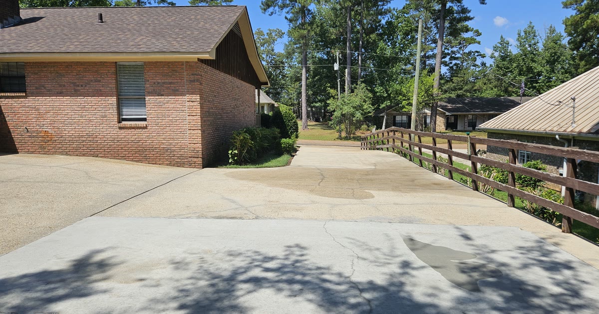 Cleaned residential driveway and brick exterior after a project in Collins, Mississippi
